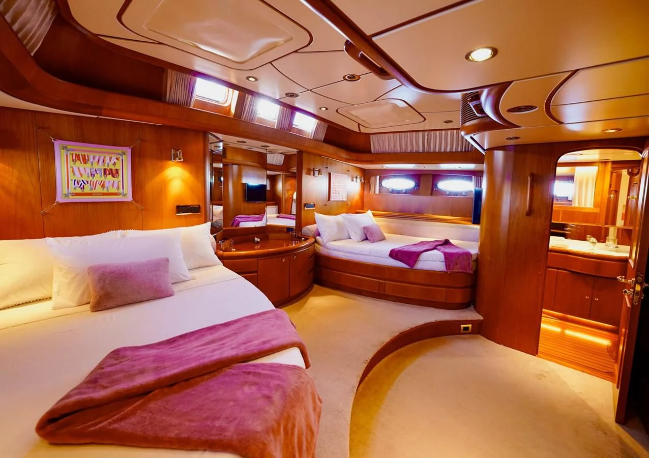a room with a bed and a table aboard JERSEY PEARL Yacht for Sale