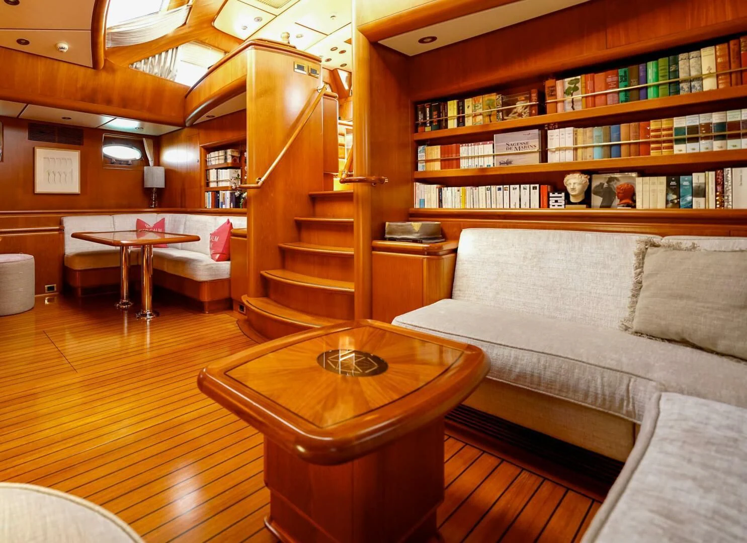 a living room with a bookcase aboard JERSEY PEARL Yacht for Sale