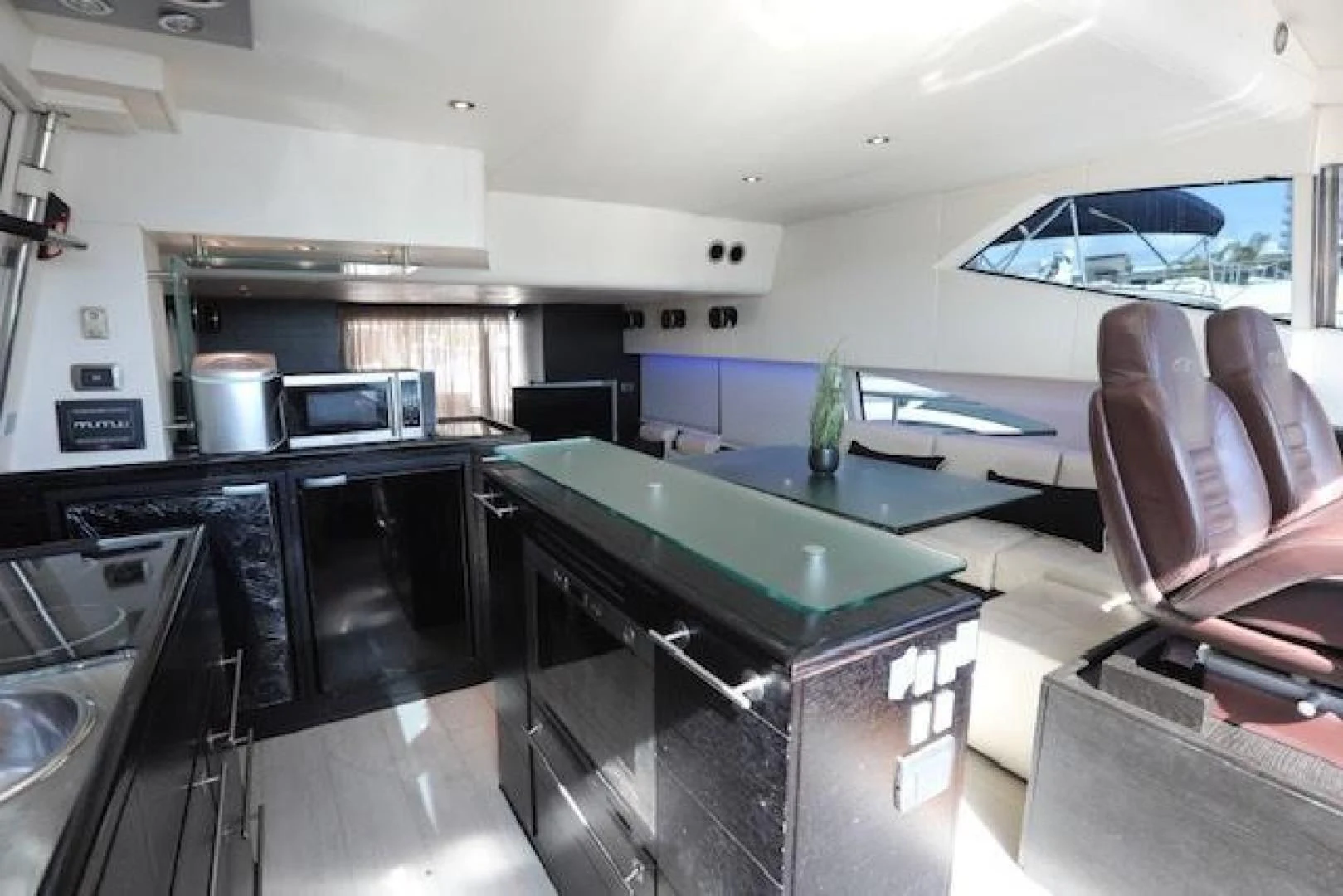 a kitchen with a bar and a table aboard K3 Yacht for Sale