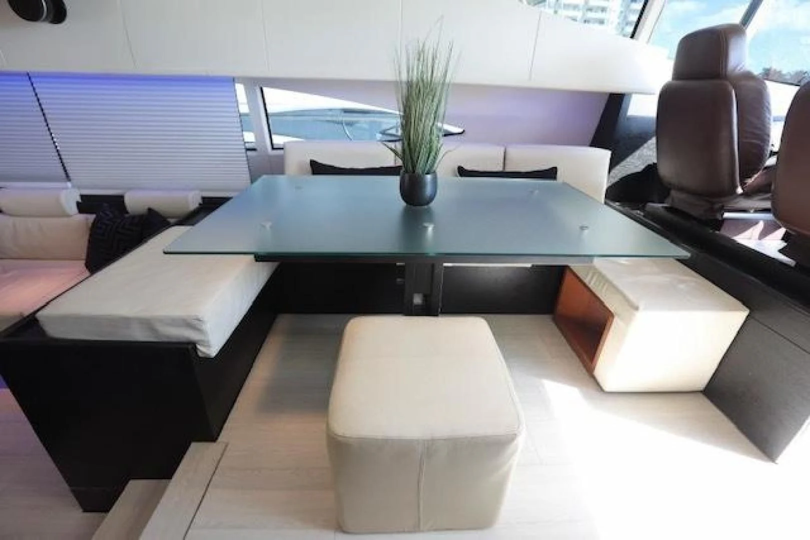 a black table with white chairs aboard K3 Yacht for Sale