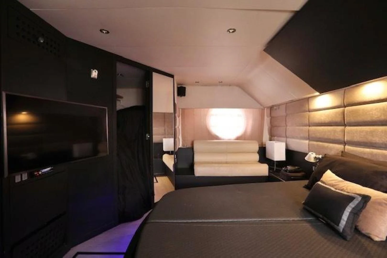 a bedroom with a bed and a tv aboard K3 Yacht for Sale