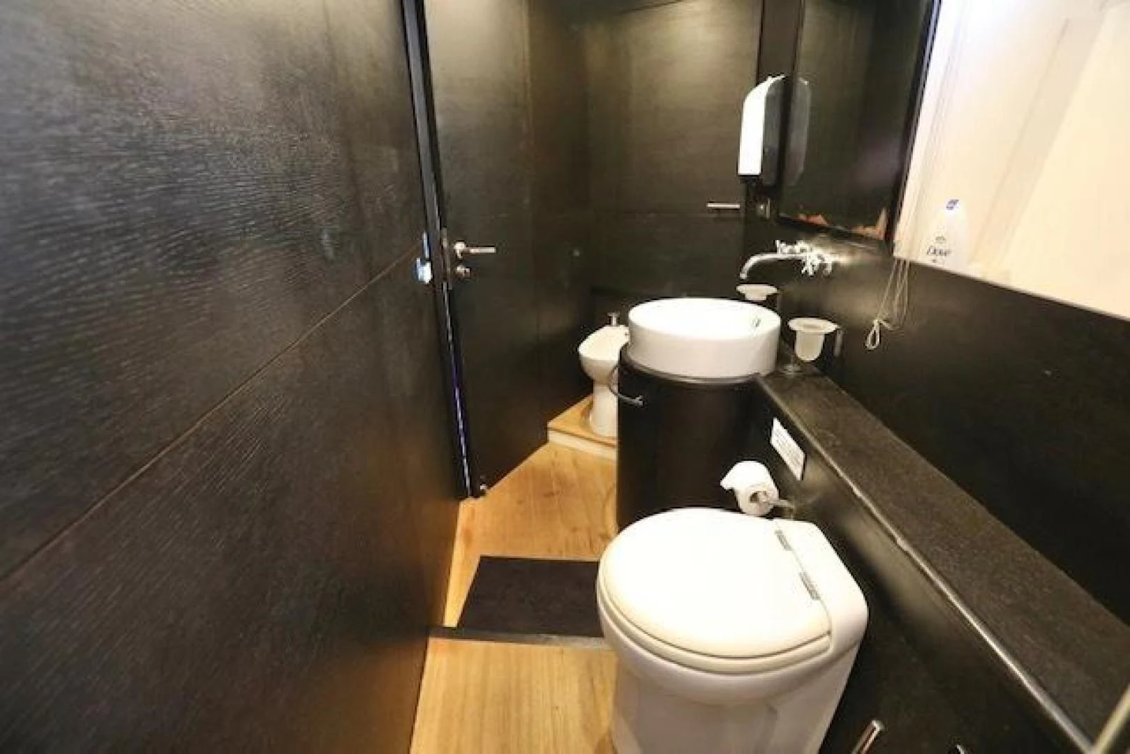 a bathroom with a toilet and a stand up shower aboard K3 Yacht for Sale