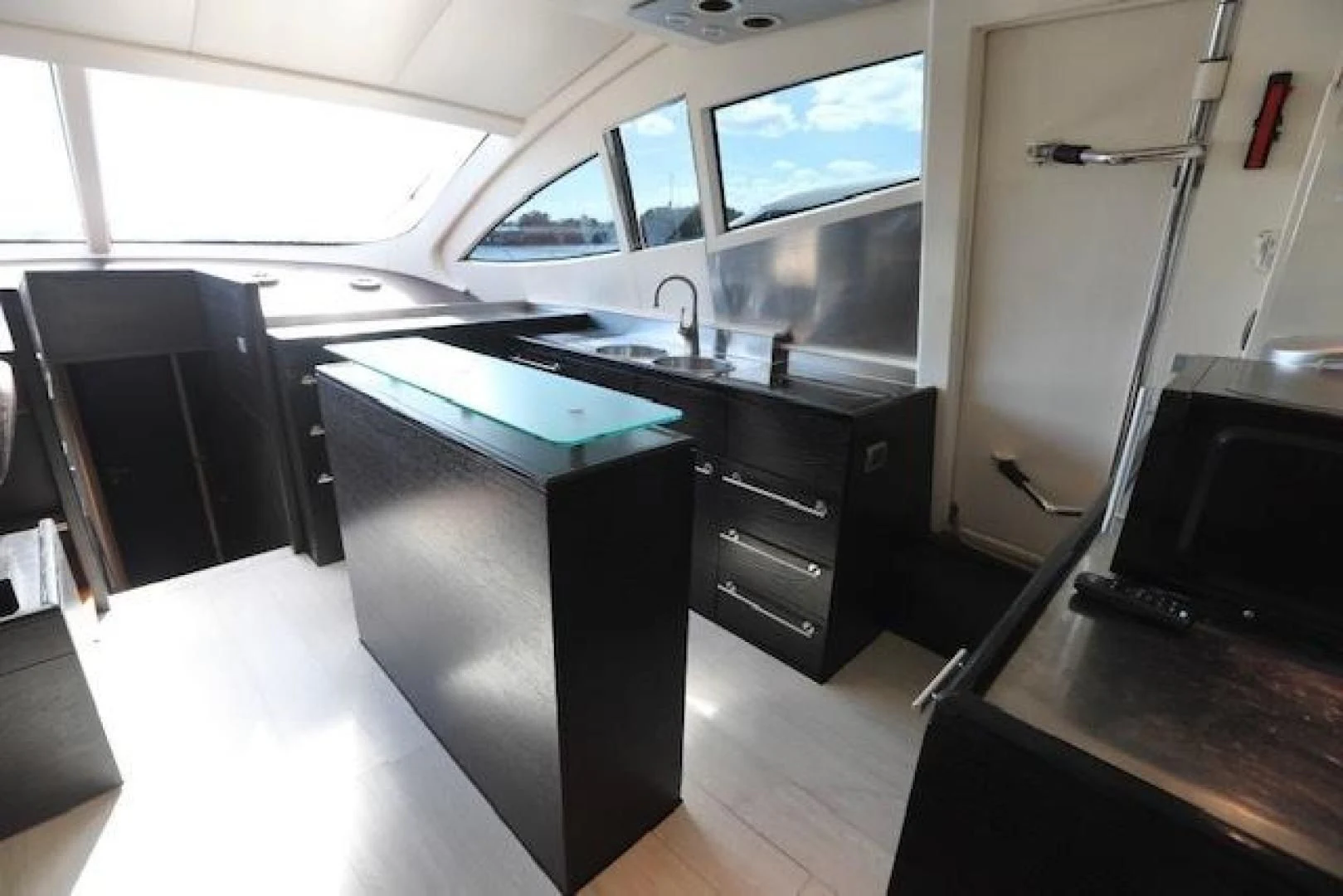 a room with a black counter and a black cabinet aboard K3 Yacht for Sale