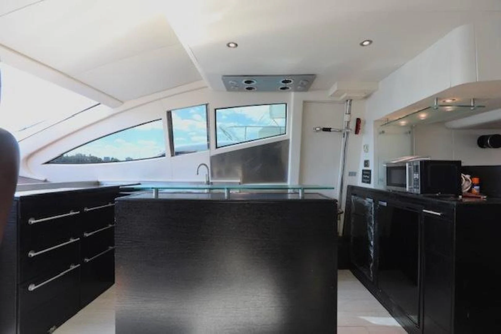 a kitchen with a bar and a tv aboard K3 Yacht for Sale