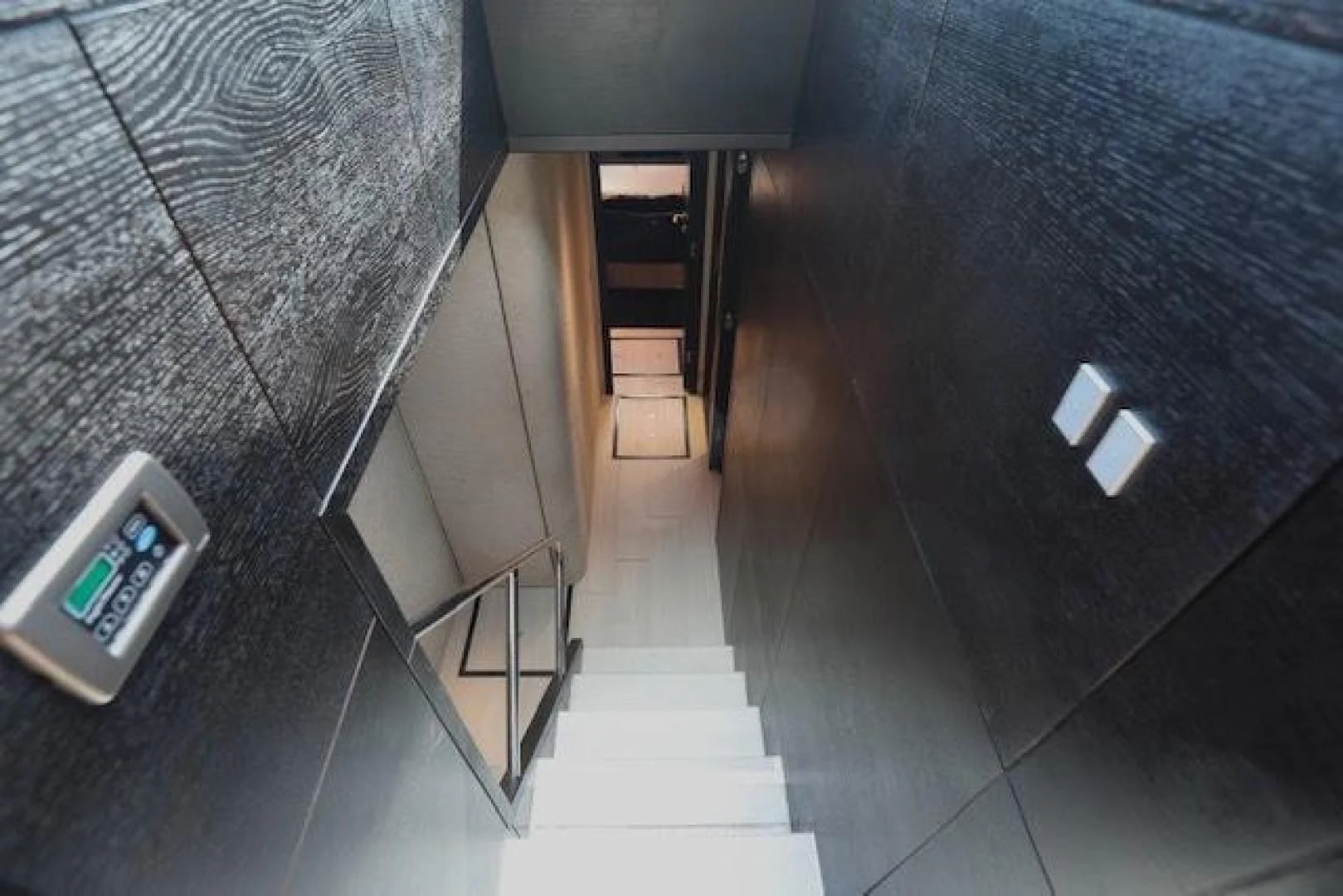 a hallway with a black wall aboard K3 Yacht for Sale