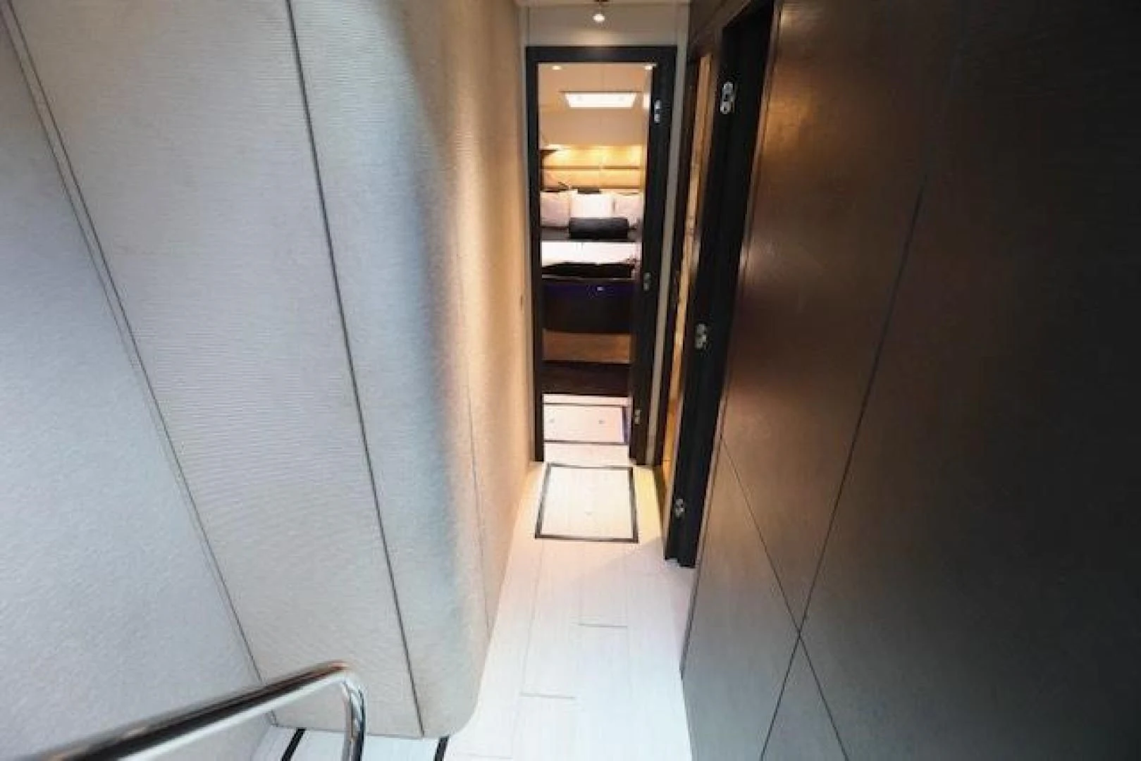 a hallway with a door and a chair aboard K3 Yacht for Sale
