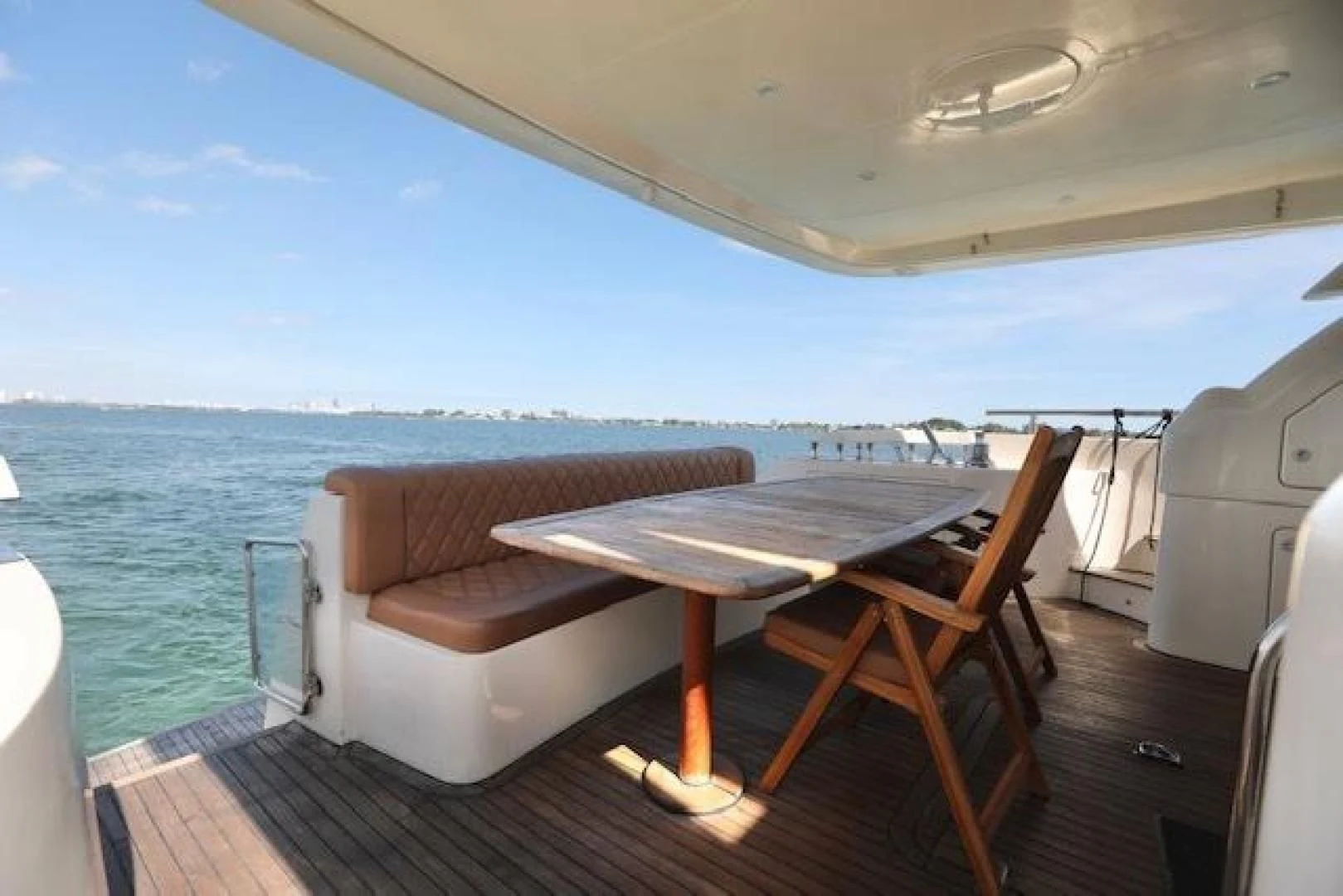 a table and chairs on a deck aboard K3 Yacht for Sale