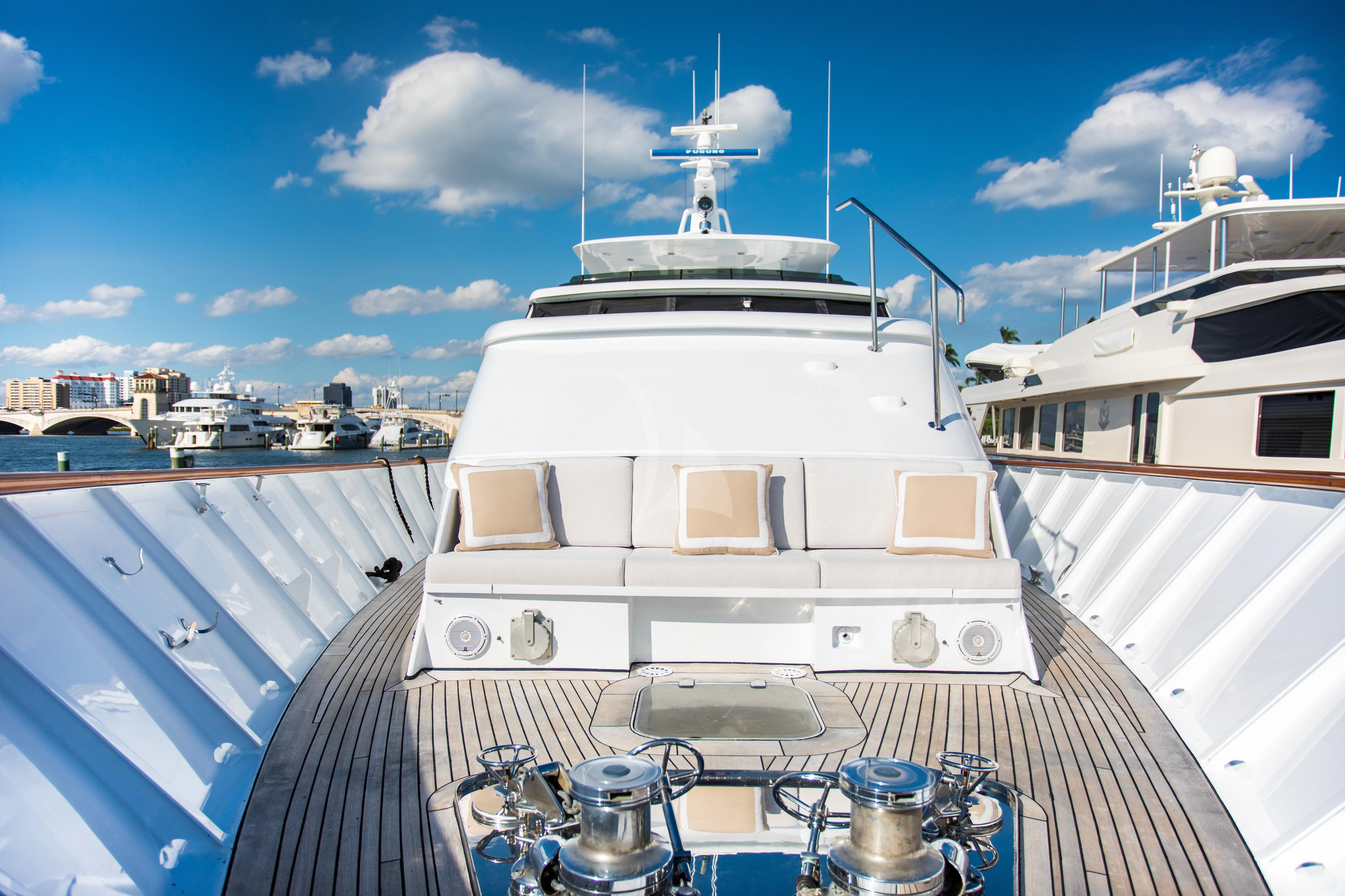 a large white boat in a harbor aboard VIAGGIO Yacht for Sale