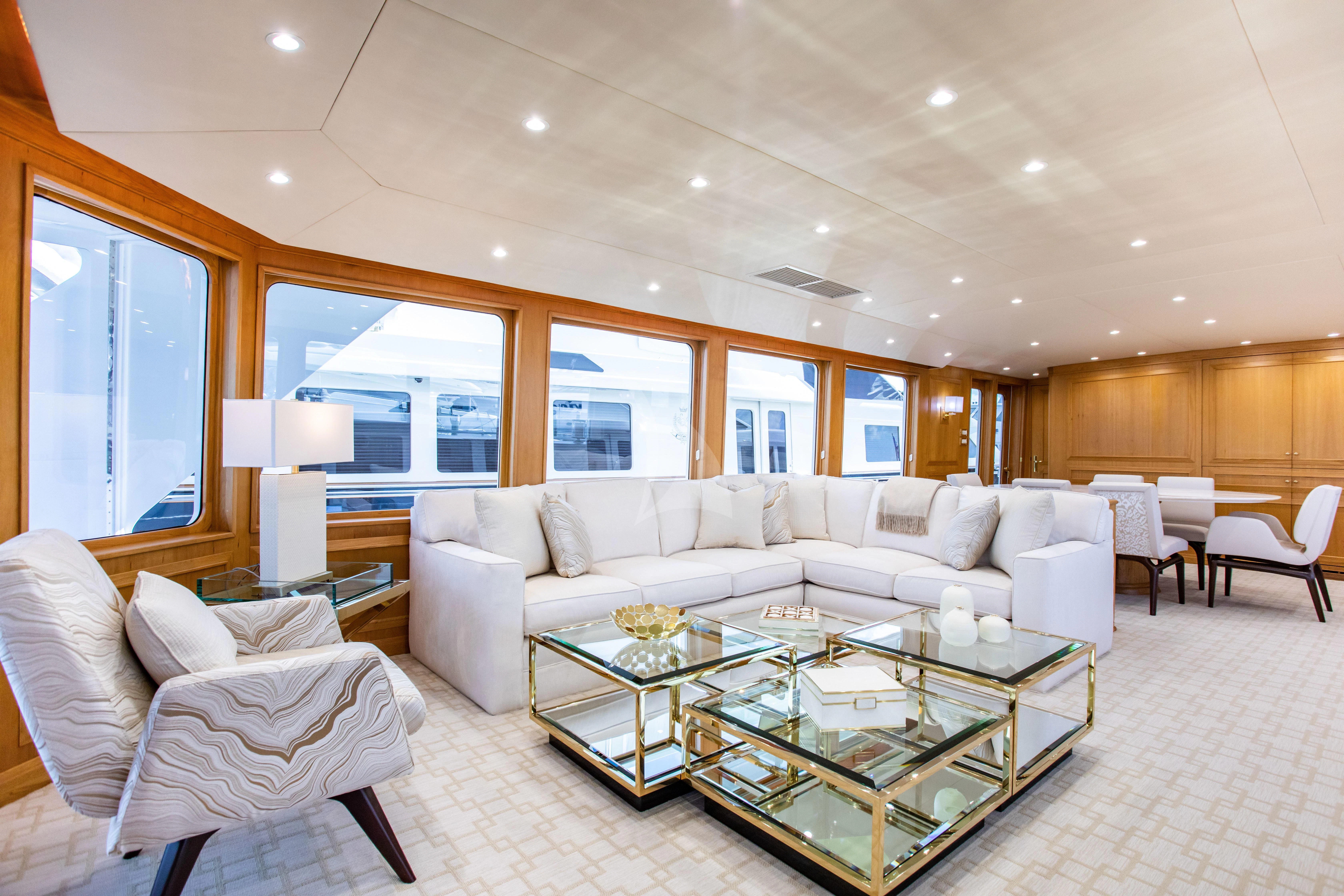 a living room with a large white sofa and a coffee table aboard VIAGGIO Yacht for Sale