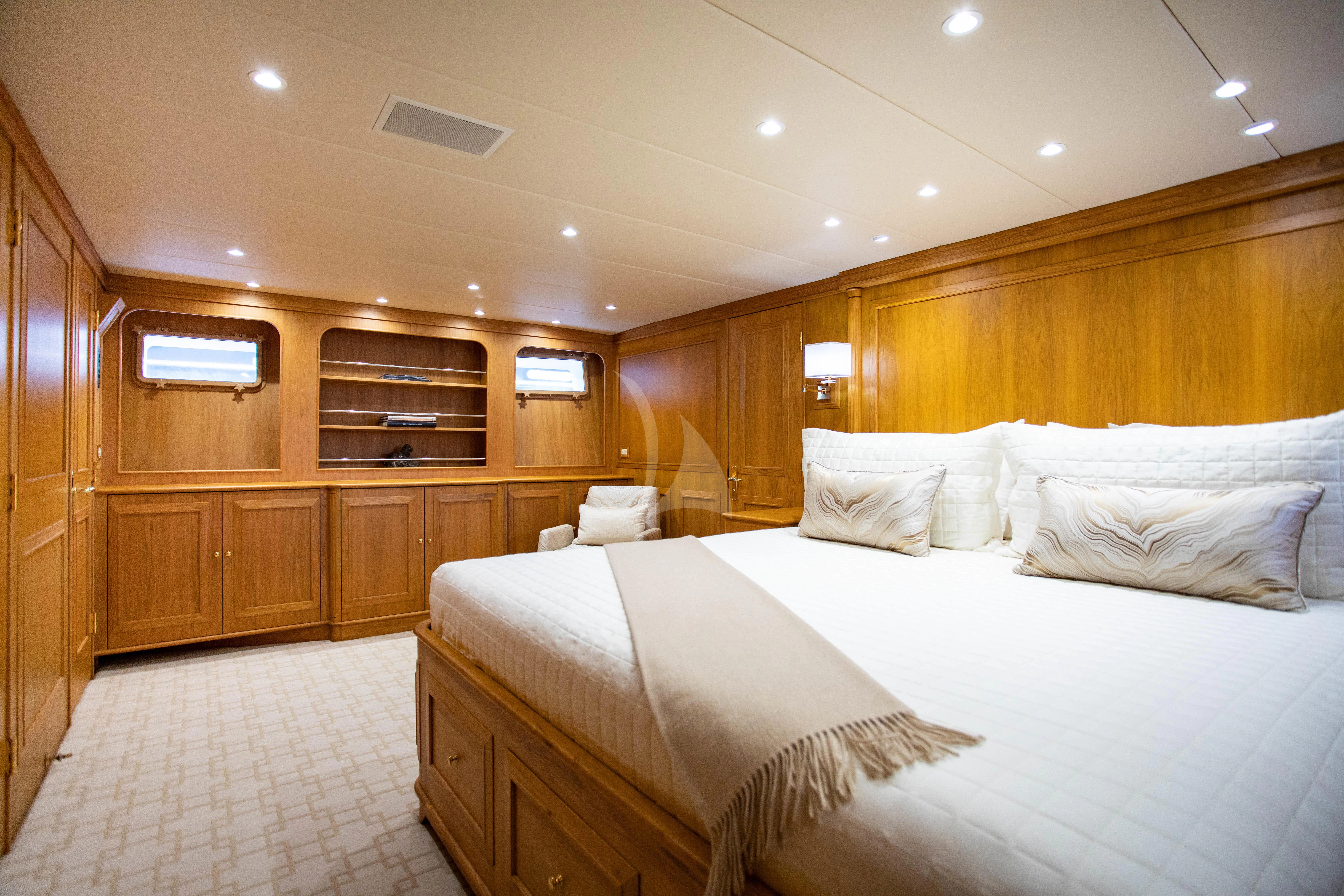 a room with wooden walls and a couple of beds aboard VIAGGIO Yacht for Sale