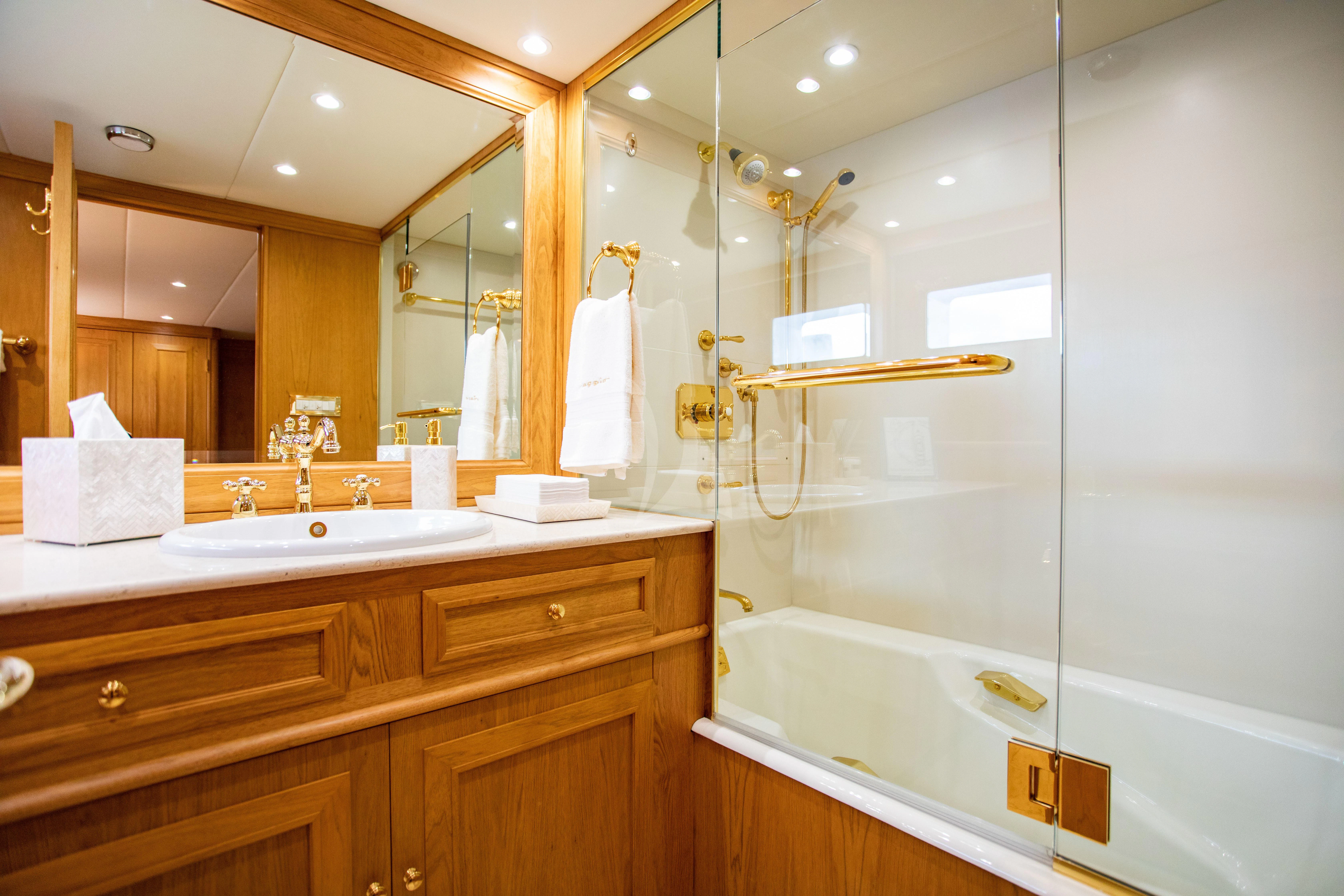 a bathroom with a glass shower aboard VIAGGIO Yacht for Sale
