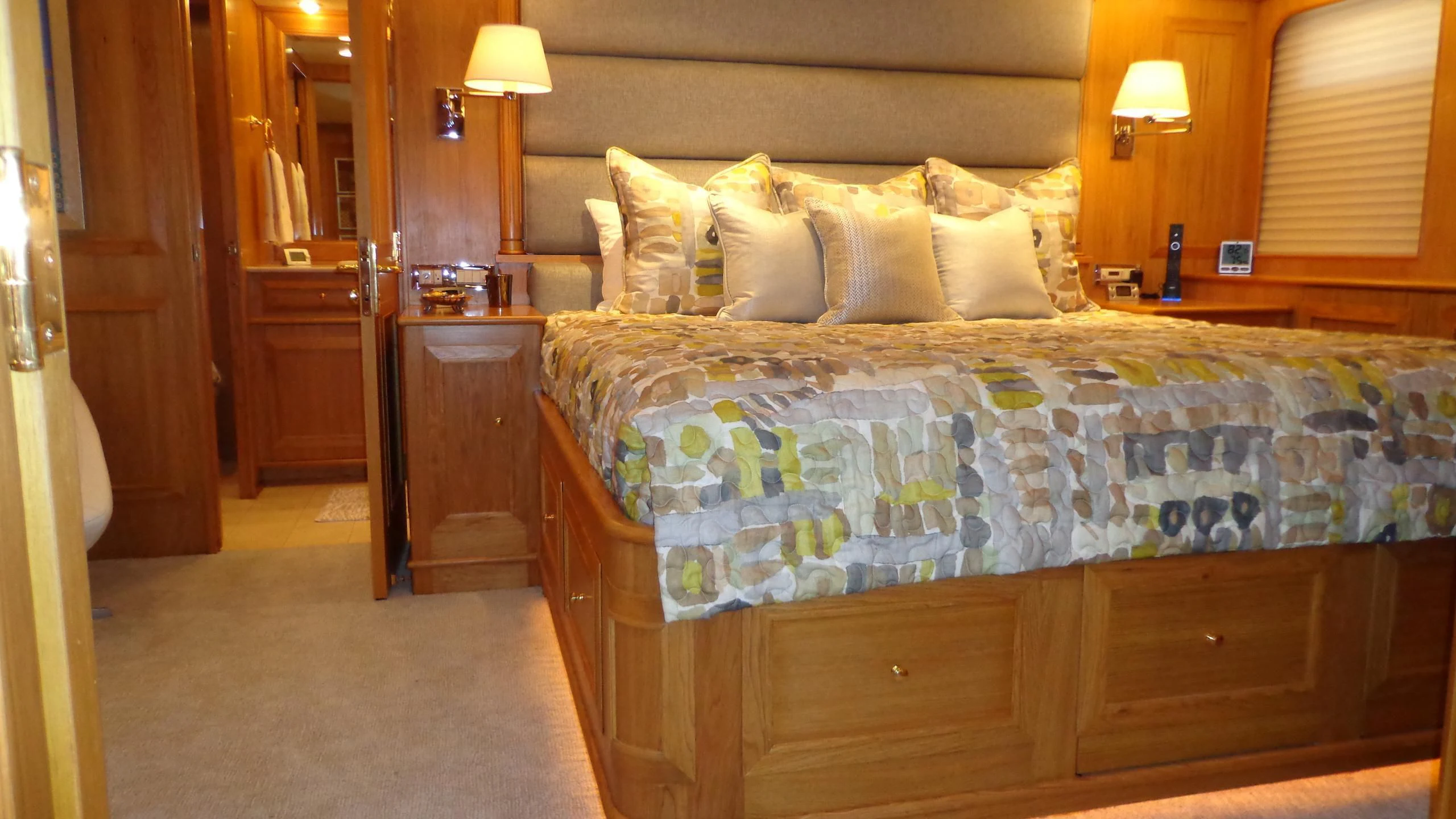 a bed with a blue comforter aboard VIAGGIO Yacht for Sale