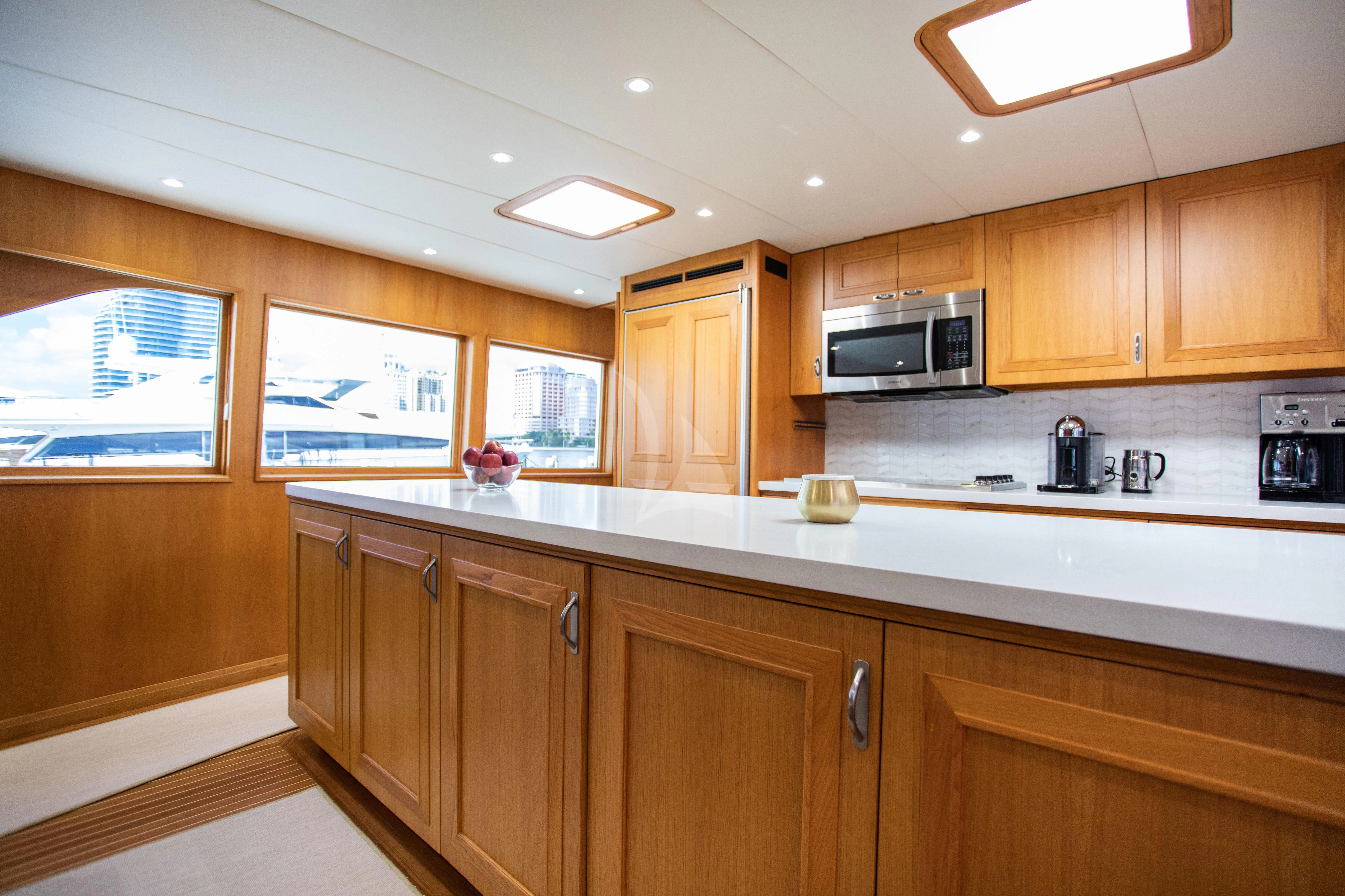 a kitchen with wooden cabinets aboard VIAGGIO Yacht for Sale