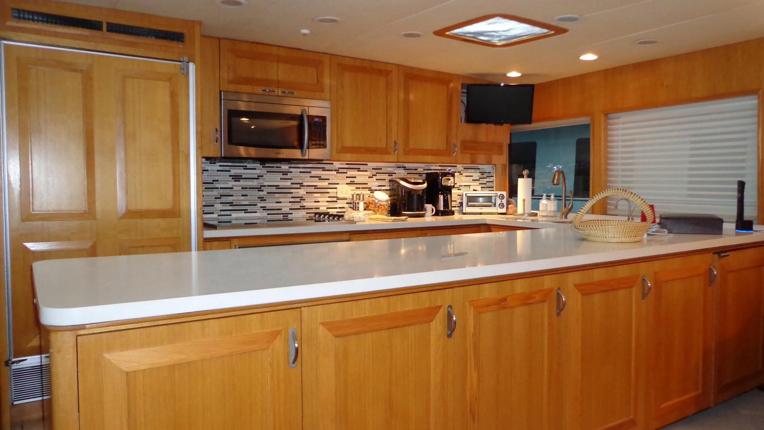 a kitchen with wooden cabinets aboard VIAGGIO Yacht for Sale