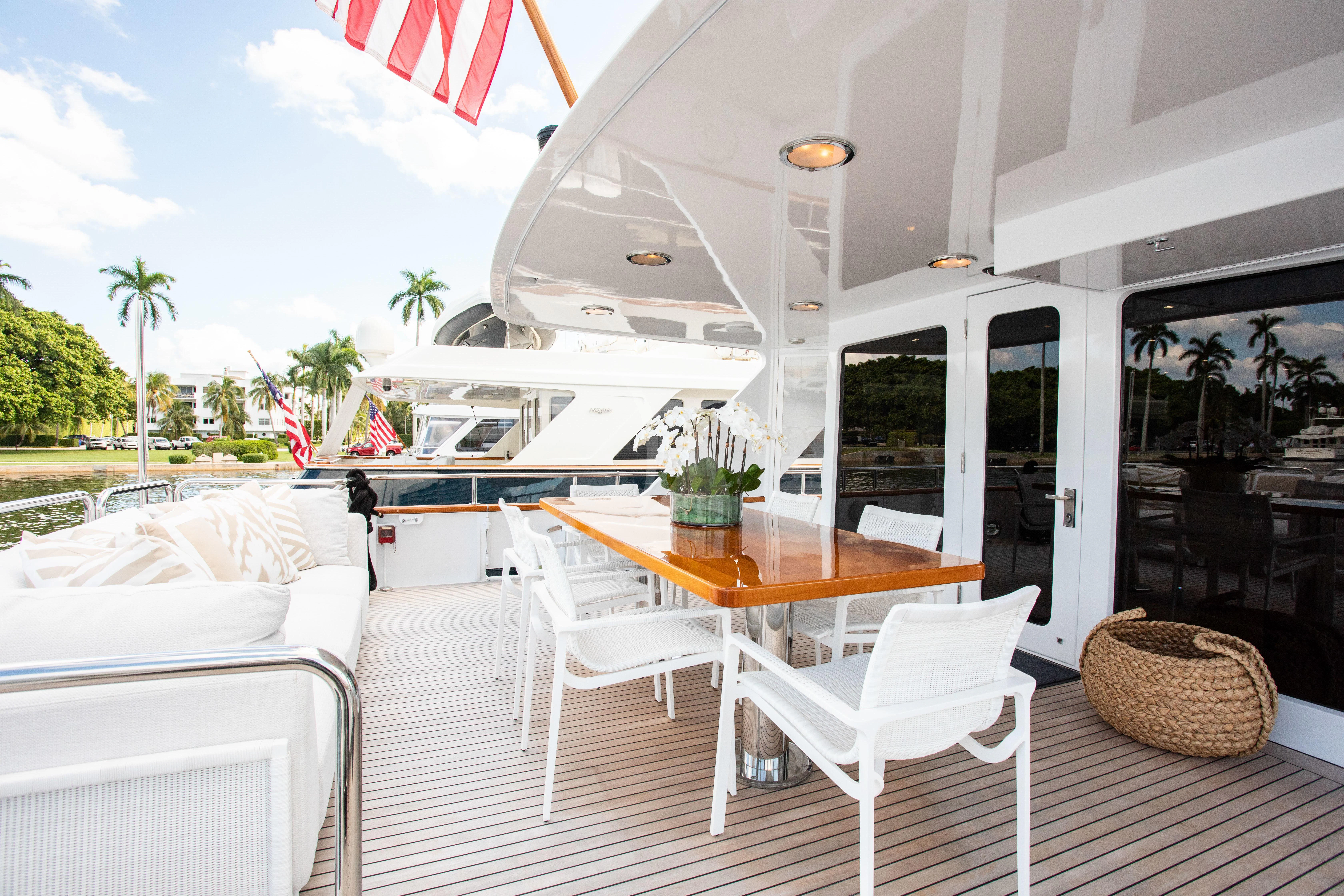 a deck with a table and chairs on it aboard VIAGGIO Yacht for Sale