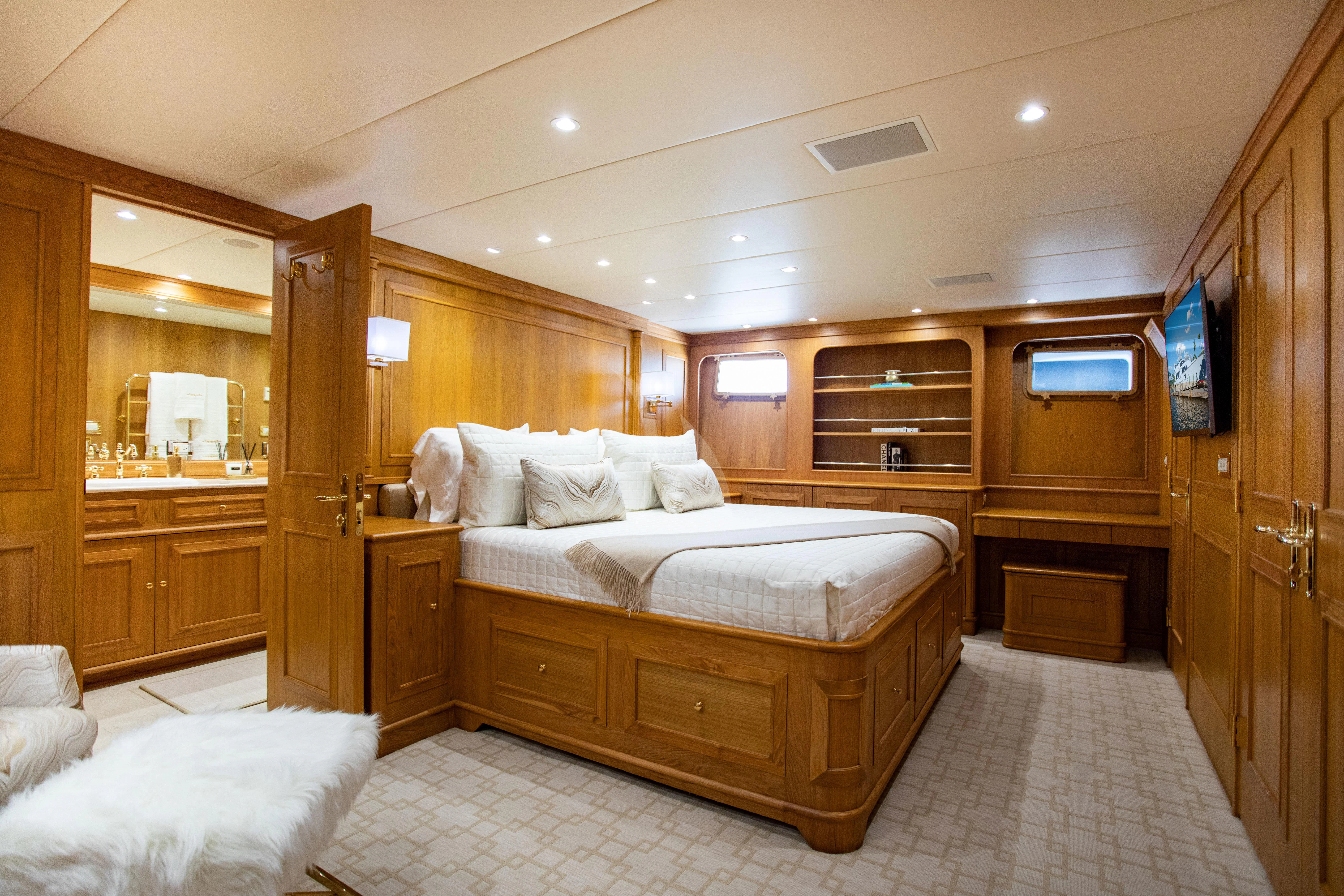 a bedroom with a bed and a mirror aboard VIAGGIO Yacht for Sale