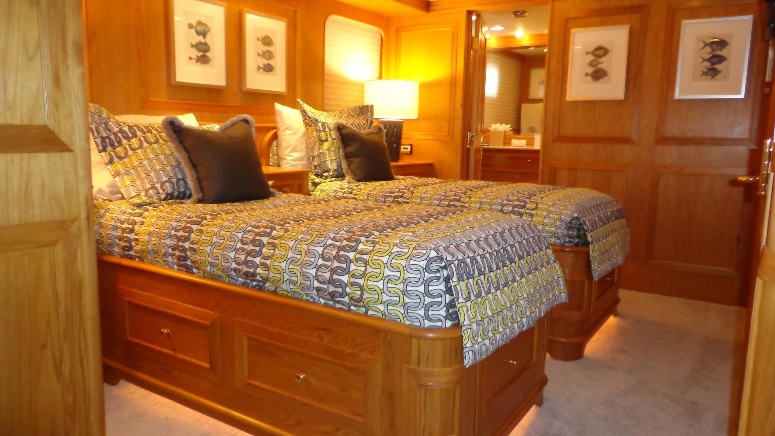 a bed with a black and white comforter and pillows aboard VIAGGIO Yacht for Sale