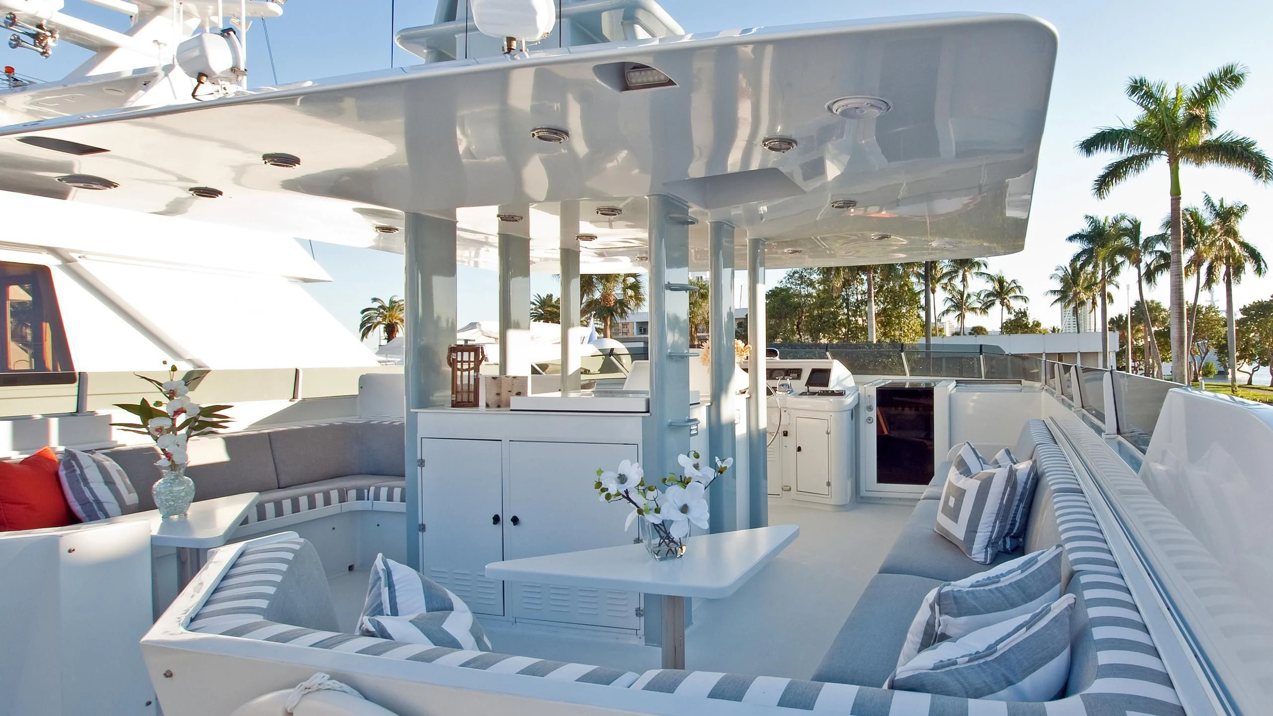 a large white tent with a table and chairs and a plant in it aboard VIAGGIO Yacht for Sale