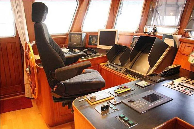 a room with a desk and computer aboard TRINTEL Yacht for Sale