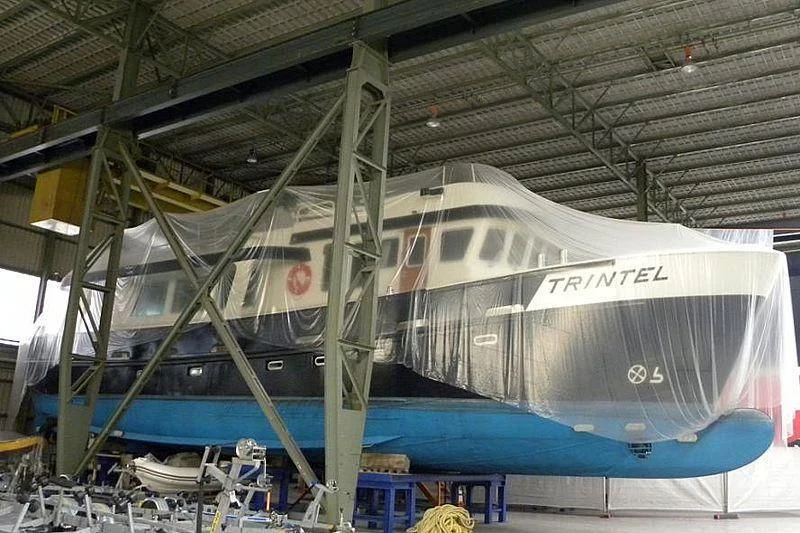 a large white and blue boat aboard TRINTEL Yacht for Sale