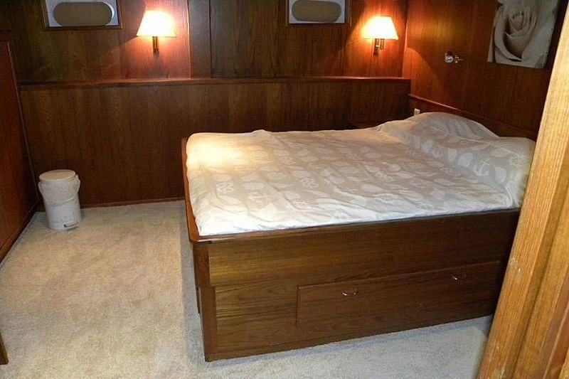 a bed in a room aboard TRINTEL Yacht for Sale