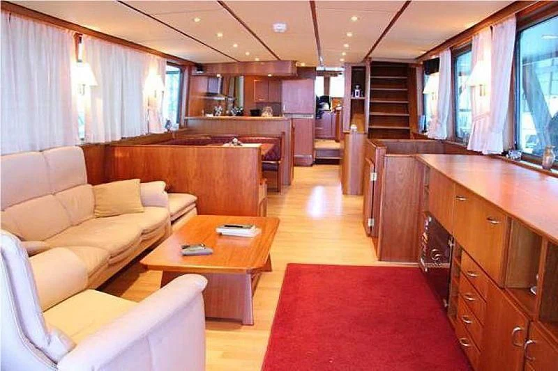 a living room with a couch and a table aboard TRINTEL Yacht for Sale