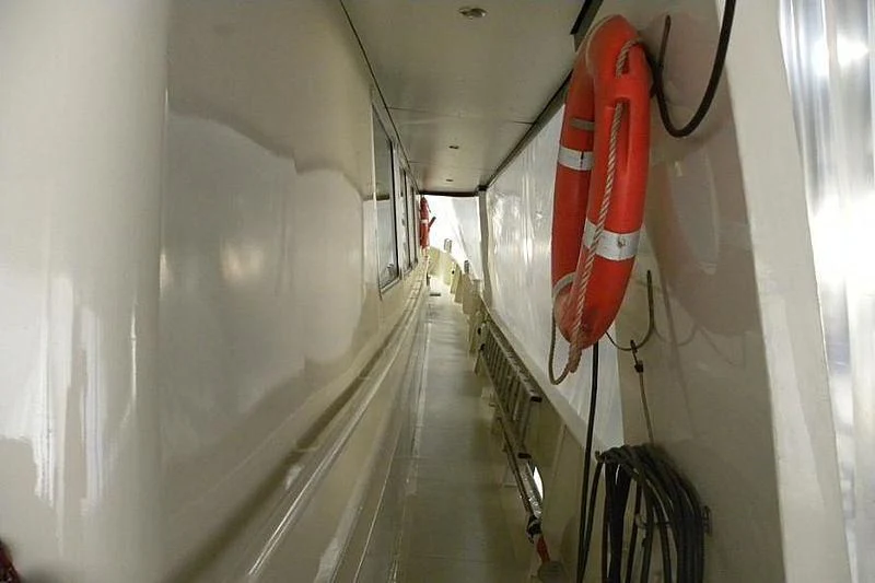 a hallway with a rack of luggage aboard TRINTEL Yacht for Sale