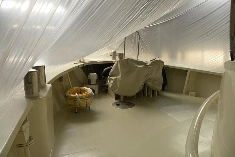 a room with a chair and a basket aboard TRINTEL Yacht for Sale