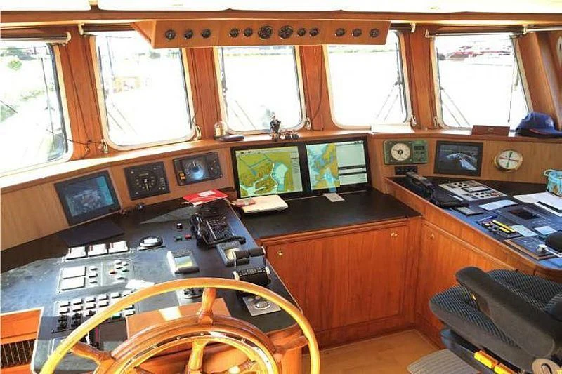 a room with a desk and a chair aboard TRINTEL Yacht for Sale