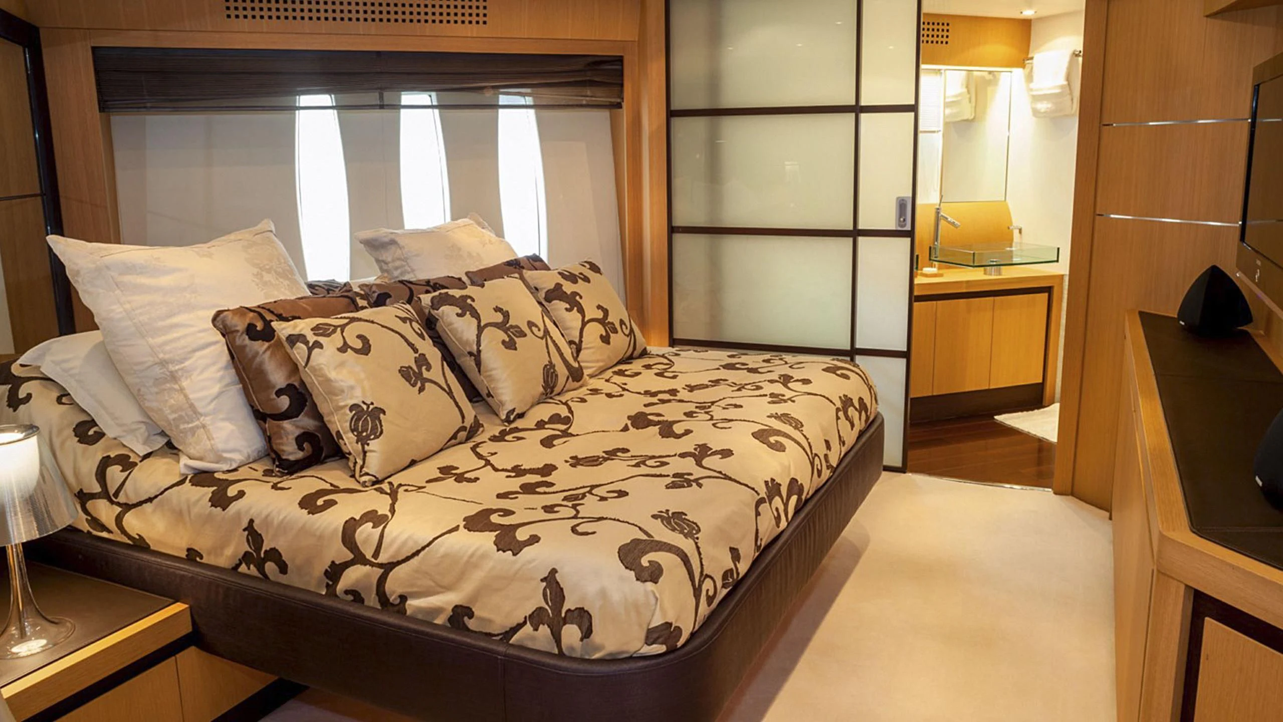 a bed with a white comforter aboard A&O Yacht for Sale