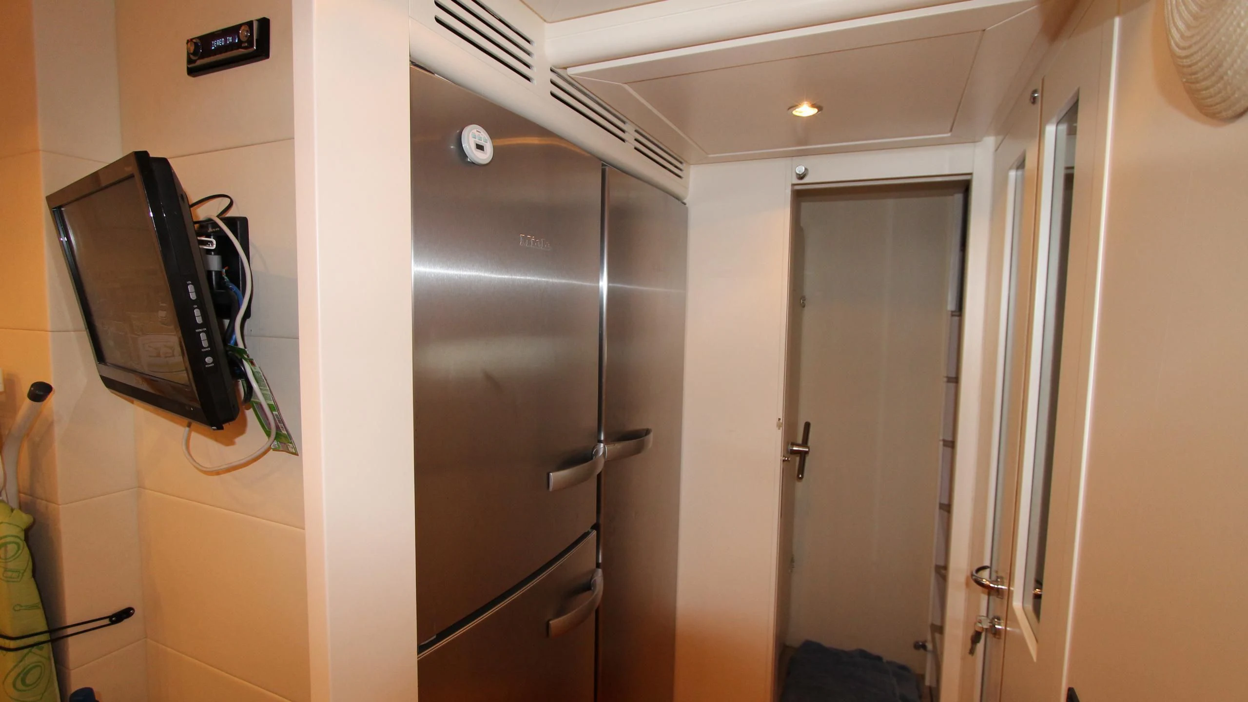 a room with a tv and a closet aboard A&O Yacht for Sale