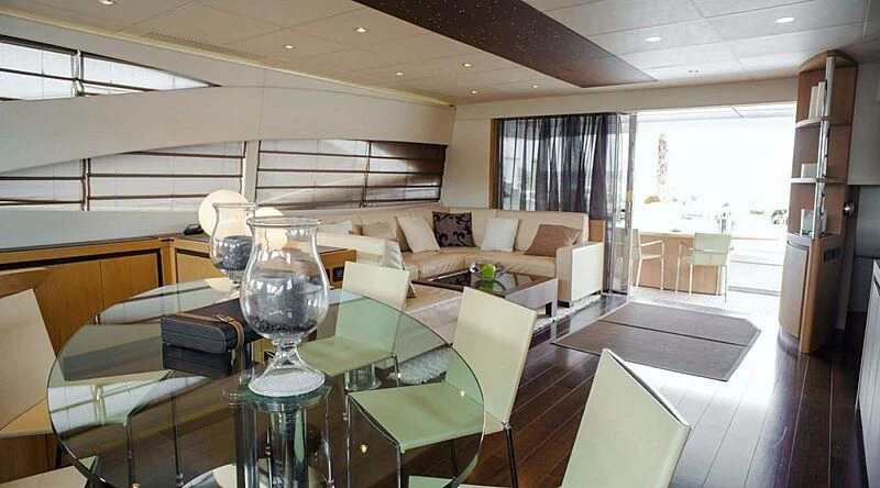 a living room with a table and chairs aboard A&O Yacht for Sale