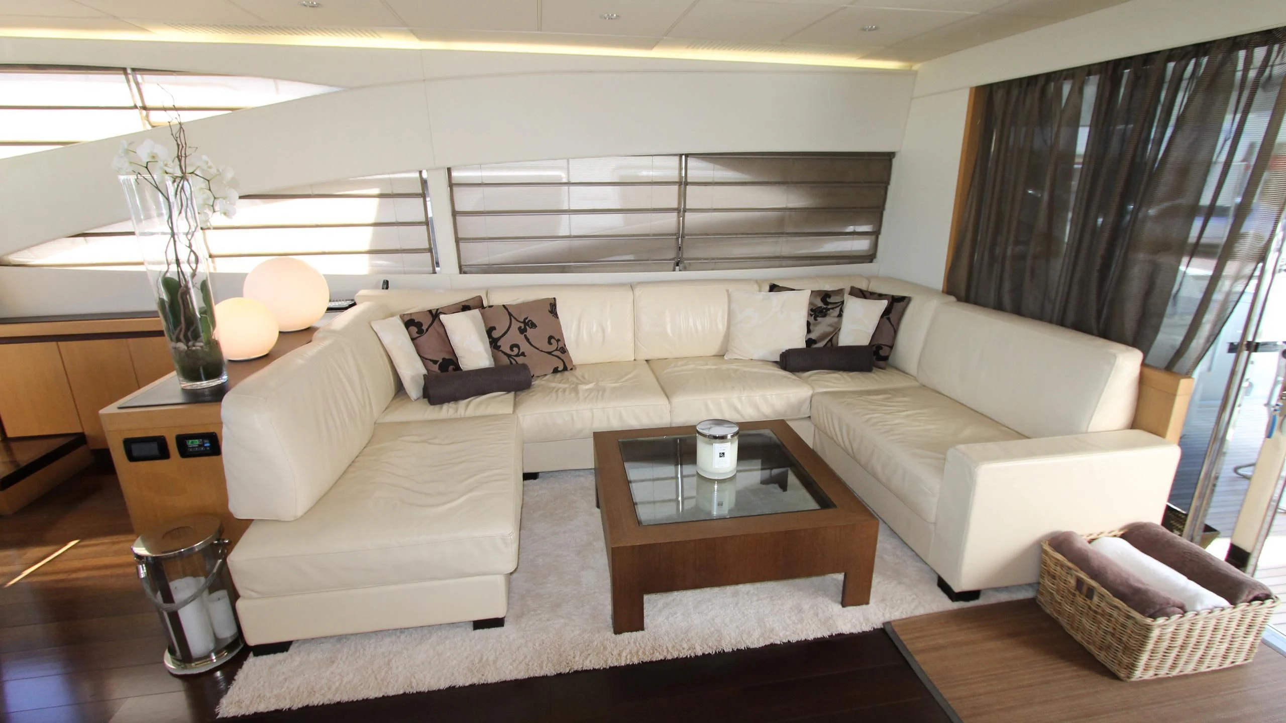 a living room with a couch and a coffee table aboard A&O Yacht for Sale
