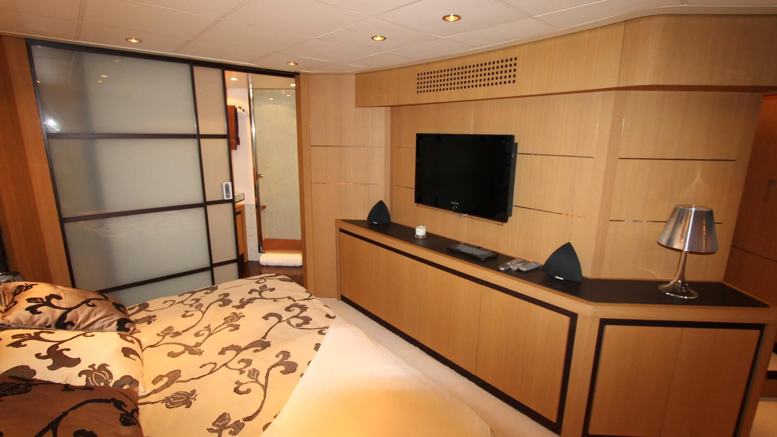 a hotel room with a tv and bed aboard A&O Yacht for Sale
