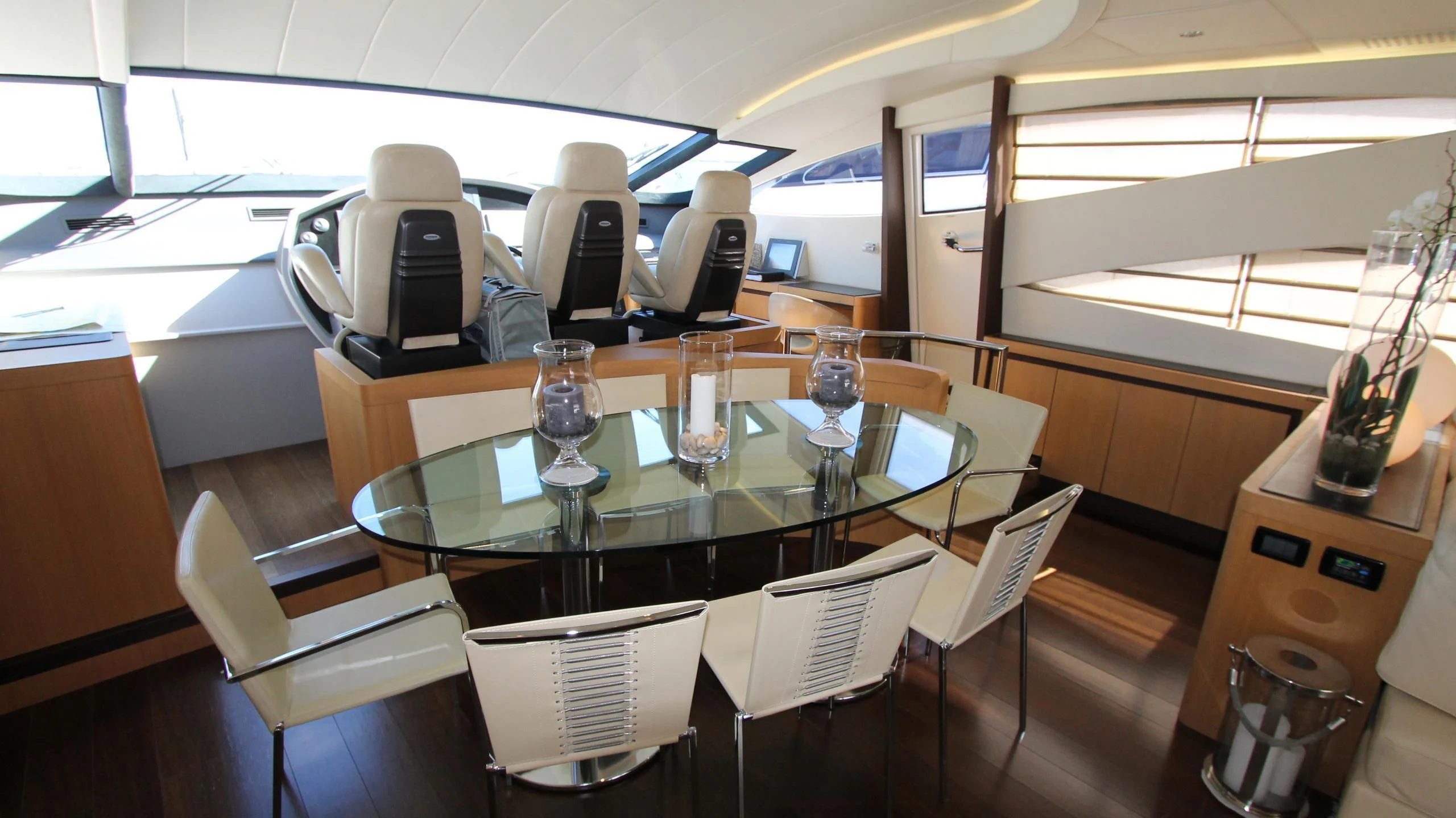 a table with wine glasses and a computer on it aboard A&O Yacht for Sale