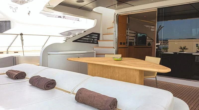 a room with a table and a bed aboard A&O Yacht for Sale