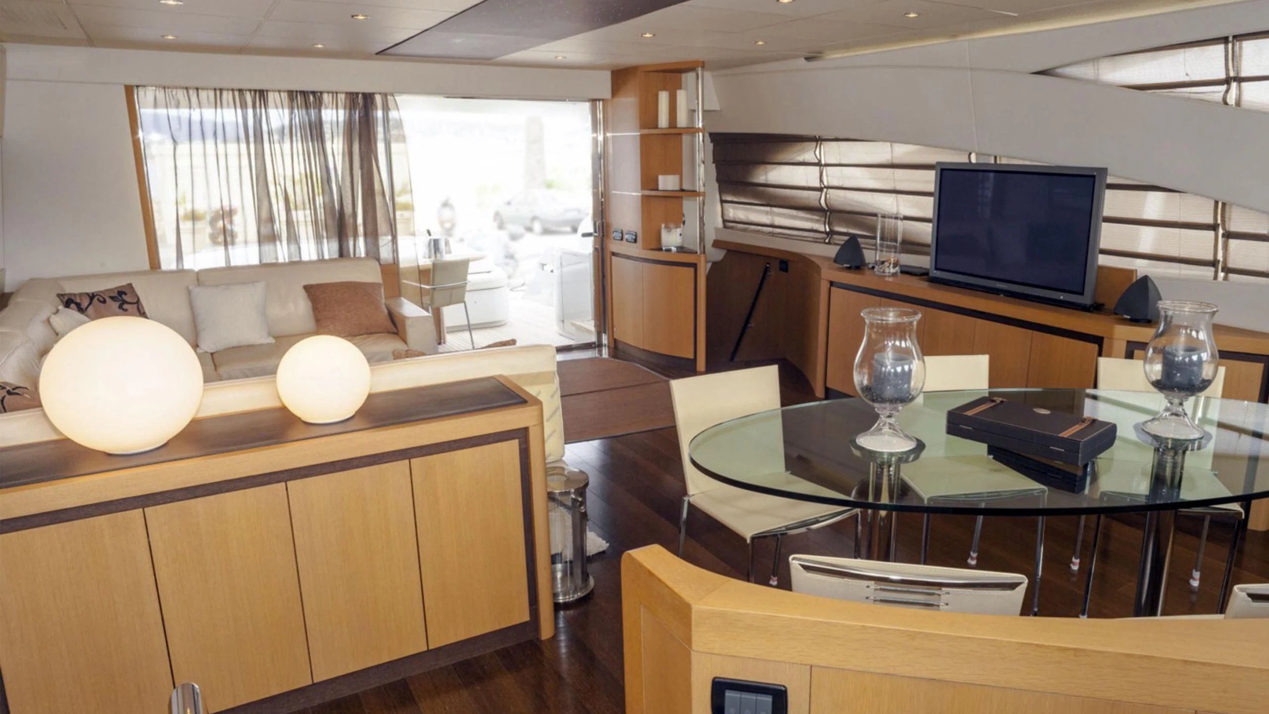 a room with a table and a tv aboard A&O Yacht for Sale