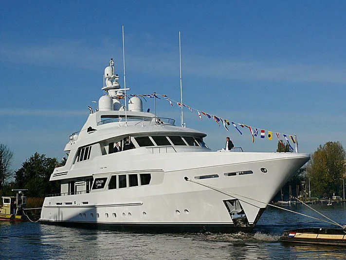 a large white boat with flags aboard KATHLEEN ANNE Yacht for Sale