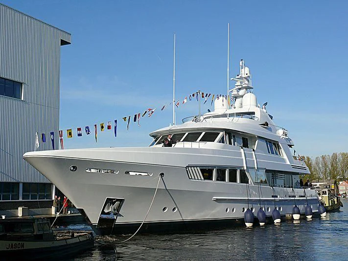 a large white boat in a harbor aboard KATHLEEN ANNE Yacht for Sale