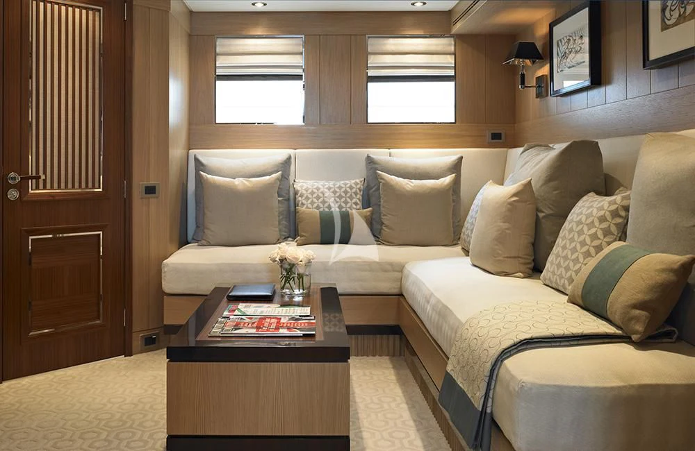 a living room with a couch and coffee table aboard KATHLEEN ANNE Yacht for Sale