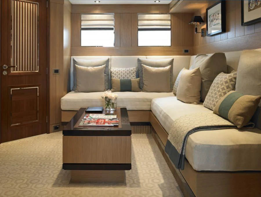 a living room with a couch and coffee table aboard KATHLEEN ANNE Yacht for Sale