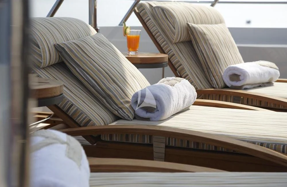 a bed with pillows and a glass of orange juice aboard KATHLEEN ANNE Yacht for Sale