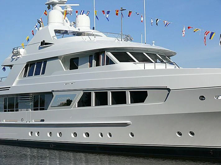 a large white boat with flags on it aboard KATHLEEN ANNE Yacht for Sale