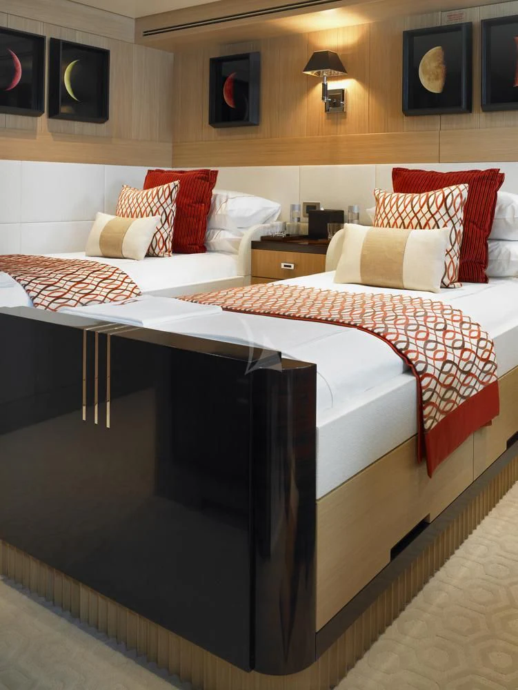a bed with a white and red blanket and pillows aboard KATHLEEN ANNE Yacht for Sale