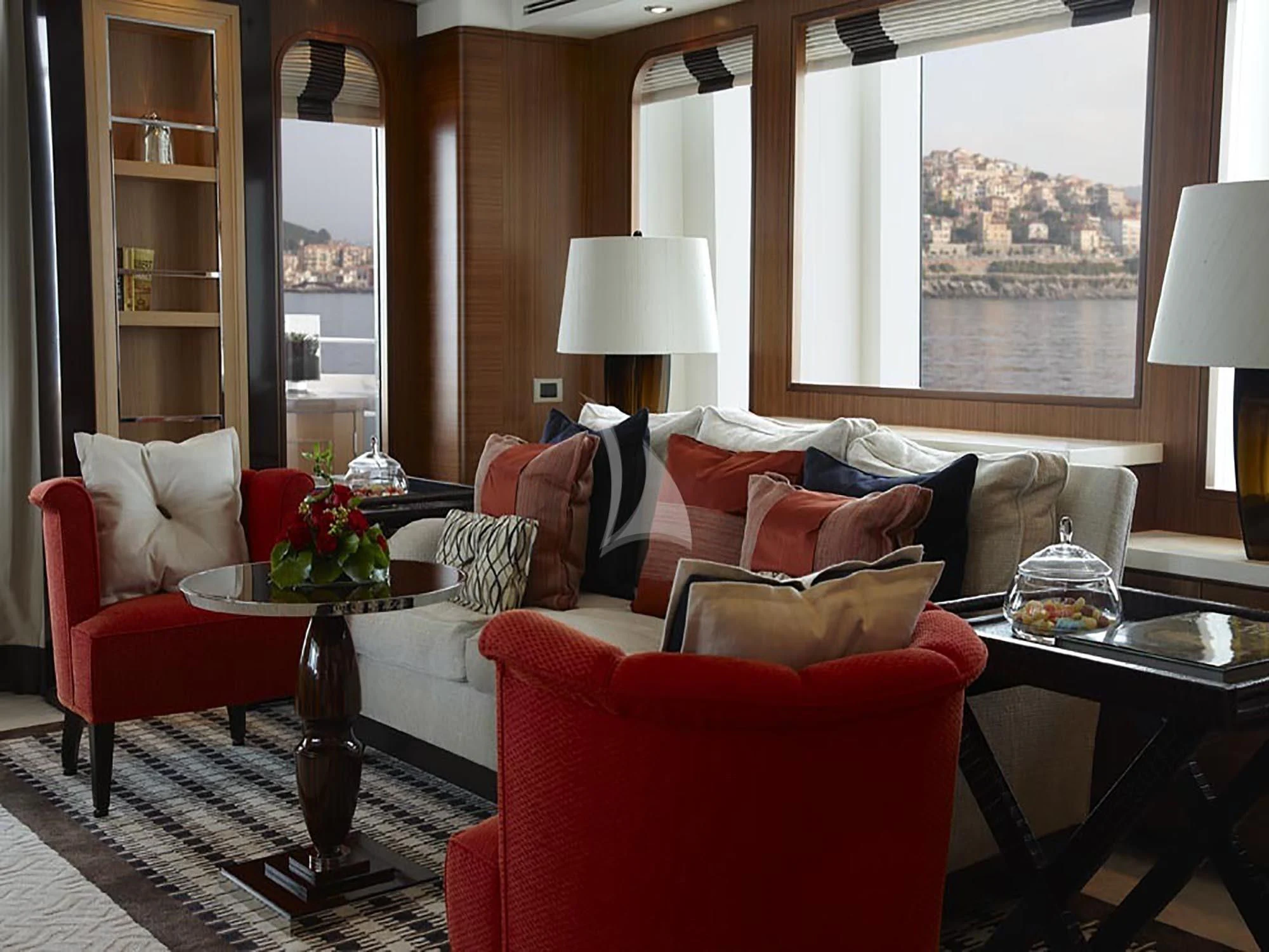 a living room with a red couch and a large window aboard KATHLEEN ANNE Yacht for Sale