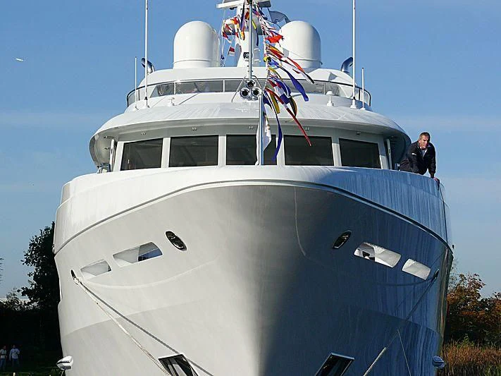 a large white boat with a couple of men on it aboard KATHLEEN ANNE Yacht for Sale