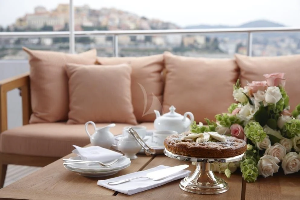 a table with a cake and a glass of tea on it aboard KATHLEEN ANNE Yacht for Sale