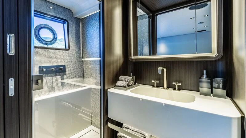 a bathroom with a sink and a mirror aboard AT ONE Yacht for Charter