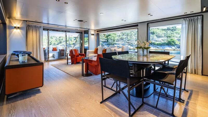 a large room with a table and chairs aboard AT ONE Yacht for Charter