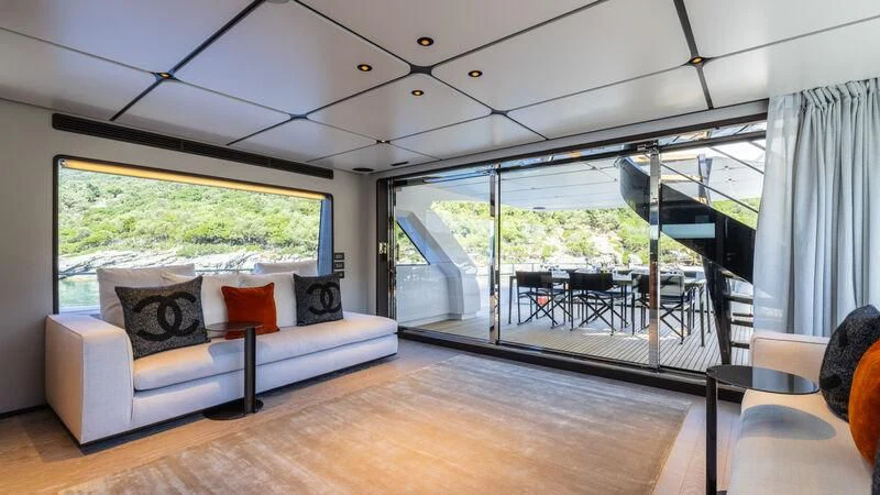 a large living room with a large screen aboard AT ONE Yacht for Charter